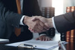 © ImageHeaven - In the oil industry, a businessman and customer seal their agreement with a handshake, marking the successful signing of an important contract.