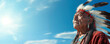 © MADMAT - Native American Elder in Ceremonial Attire on a Sky Blue Background with Space for Copy.