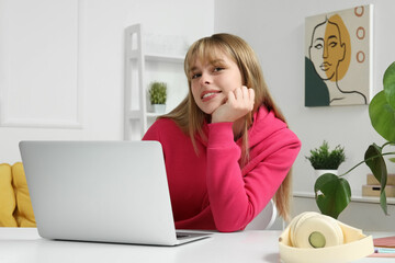 Poster - Female student with laptop doing lessons at home