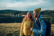 © Zamrznuti tonovi - Couple of hikers hugging and walking on a mountain trail during their vacation in a nature