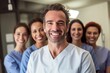 © Anne Schaum - Portrait of smiling doctor standing in front of his team in hospital