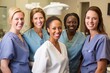 © Anne Schaum - Portrait of a group of smiling female dentists standing in a dental office