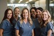 © Anne Schaum - Portrait of smiling female dentists standing in dental office with arms crossed