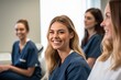 © Anne Schaum - Portrait of smiling nurse with colleagues in background at hospital. Focus on woman