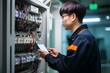 한국의 아파트 단지 지하에서 주차장과 연결된 배전반을 전기 기술 전문 엔지니어가 태블릿 기기로 점검하고 있는 모습