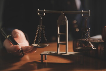 Business and lawyers discussing contract papers with brass scale on desk in office. Law, legal services, advice, justice and law concept picture with film grain effect