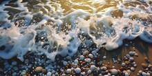 Sea Foam Wave And Wet Pebbles On The Beach, Low Angle