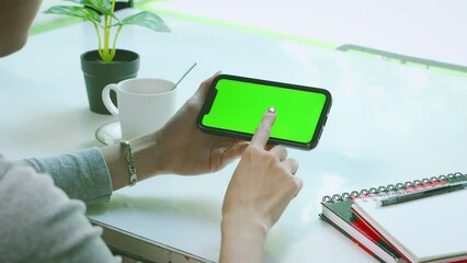 Poster - 4K video of woman holding smart phone with blank green screen, mockup template footage. 
