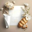 A white sheet, a blank sheet, with a cube, surrounded by bread and white flowers.