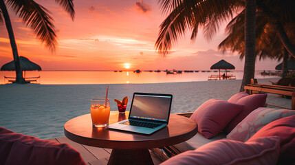 Wall Mural - table with a laptop and cocktails on the background of the tropical sea.