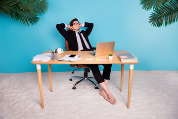 Sticker - Photo of positive employee sitting table hands over head dream about vacation isolated blue color background