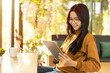© Kung37 - Beautiful Asian young woman in the cafe, using digital tablet and drinking coffee with sunlight.