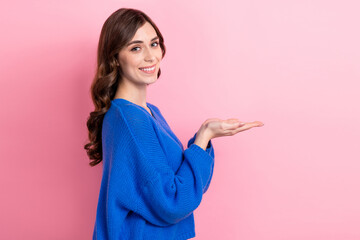 Sticker - Photo portrait of attractive young woman hold palms empty space look camera wear trendy blue clothes isolated on pink color background