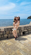 young mom kisses her daughter at the sea shore in Montenegro