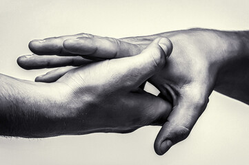 Wall Mural - Close up help hand. Two hands, helping arm friend, teamwork. Helping hand concept and international day of peace, support. Closeup hand stretch. Helping hand outstretched, salvation. Black and white