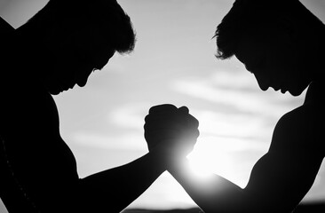 Wall Mural - Rivalry, closeup of male arm wrestling. Men measuring forces, arms Two men arm wrestling. Black and white