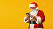 santa claus with smartphone on yellow background, christmas and new year banner template
