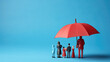 © MP Studio - Plastic figures in the form of a family protected by a red umbrella. Insurance concept. Created with Generative AI technology.