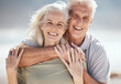 © Talia Mdlungu/peopleimages.com - Beach portrait, hug and senior happy couple relax for outdoor wellness, nature freedom or travel holiday. Love, care and elderly woman, old man or marriage people hugging on romantic vacation date