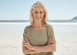 © Talia Mdlungu/peopleimages.com - Beach portrait, arms crossed and senior woman relax for outdoor wellness, nature freedom or travel holiday in Canada. Sand, ocean sea water and elderly person smile for retirement vacation happiness