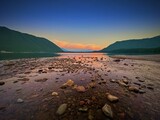 Fototapeta Morze - Sunset along the shoreline of Lake McDonald, Glacier National Park, MT.
