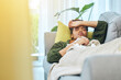 © Joshua A/peopleimages.com - Black woman, sick and tired, sleep on couch and recovery from illness and health, virus and burnout. Relax on sofa in living room, healthcare and wellness with influenza, disease and fatigue at home