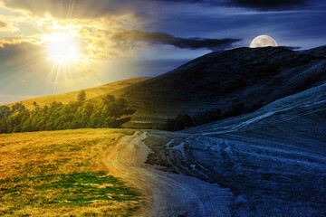 Wall Mural - early autumn mountain landscape with path through the hillside with sun and moon at twilight. day an