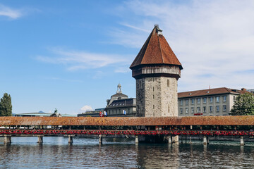 Wall Mural - The Kapellbrucke (literally, Chapel Bridge), a covered wooden footbridge spanning the river Reuss diagonally in the city of Lucerne in central Switzerland