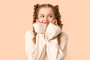 Poster - Beautiful happy young woman in warm sweater on beige background