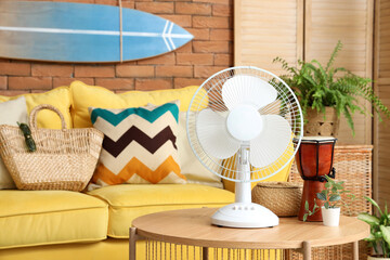 Poster - Electric fan and decor on wooden coffee table in stylish living room