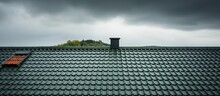 Gray Sky Background With Green Roof Tiles And Architectural Details On House Roof