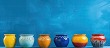 Colorful Empty Ceramic Pots On Blue Background