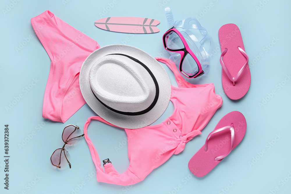 Composition with different beach accessories on color background