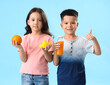 © Pixel-Shot - Little Asian children with fresh citrus juice, orange and squeezer showing thumb-up gesture on blue background
