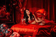 Portrait Of Smile Sexy Asian Girl Glam Makeup In Red Lace Lingerie Lying On Bed At Valentines Day