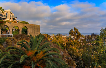 Wall Mural - Sunset over luxury homes, a beautiful palm tree and boats in Dana Point harbor, Orange County in Southern California on a cloudy day, panoramic view