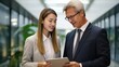 © visoot - Business people team are working and using digital tablet tech discussing financial market data at corporate office meeting.