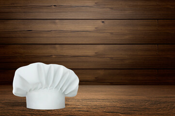 Wooden table with empty space and chef's hat