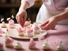 Pastry Chef  Hands Decorating Pink Petit Fours, Mini Desserts 