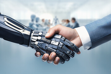 Closeup of handshake between human businessman vs AI humanoid robot - Futuristic shaking hands in the modern meeting room between human people and cyborg robots - Artificial intelligence concept.