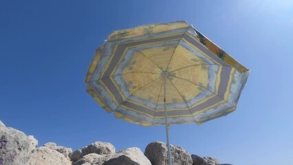 Poster - Beach umbrella on the background of blue sky.