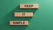 Keep it simple words on wooden blocks. Business copywriting concept.3D rendering on green background.
