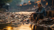 Unidentified poor man sitting on the bank of the river in India.