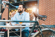 © Dorde - Handsome businessman sitting in the restaurant and having a breakfast. Smiling man spending his time outdoors and having a good time.