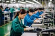 Asian workers on high tech factory assembly line smartphone manufacturing electronics factory microchip production engineering mechanics technicians industrial warehouse technology labor workers
