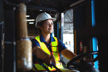 Professional Workers In The Warehouse. Female Worker Driving A Forklift In A Warehouse Worker Working In Warehouse