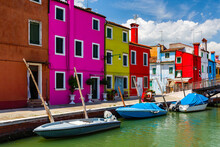 Beautifully Colored Buildings Next To Narrow Canals On The Italian Island Of Burano, Near Venice