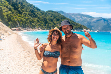 Wall Mural - A couple of tourists at Gidaki Beach on the island of Ithaki or Ithaca in the Ionian Sea in the Mediterranean Sea of Greece