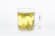 Tea brewing process in transparent glass cup. Dragon Well green tea (Longjing tea).