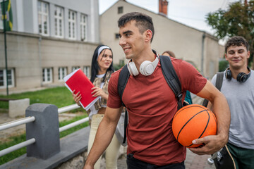 Wall Mural - group of teenage students gen z walk in front of school university